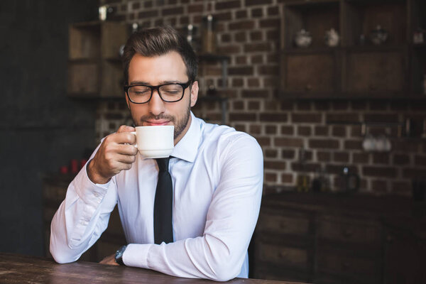 businessman drinking coffee at cafe