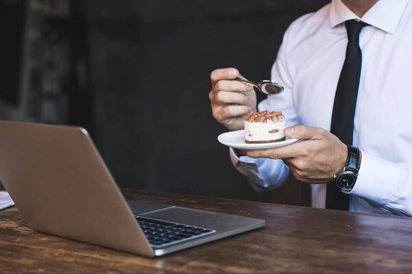 businessman with laptop and cake