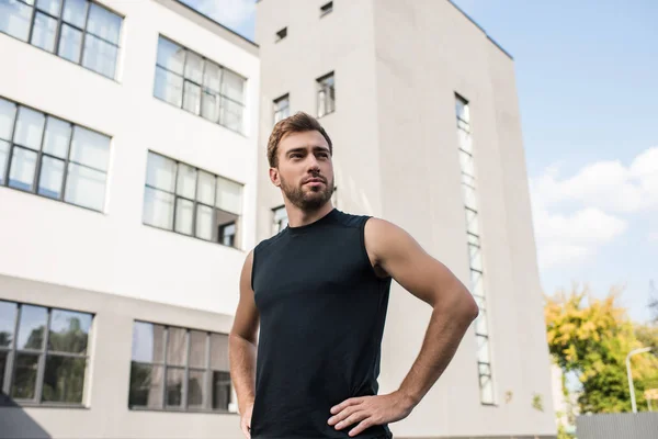 Hombre en ropa deportiva de pie akimbo —  Fotos de Stock