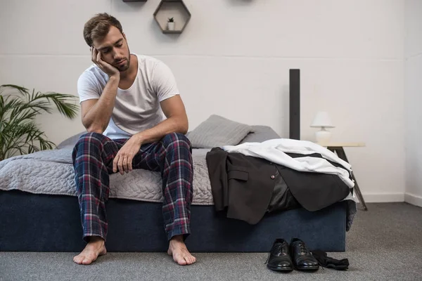 Depositphotos 168750624 Stock Photo Sleepy Man Sitting On Bed