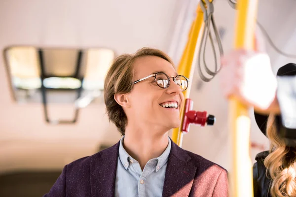 Smiling young man in bus — Stock Photo, Image
