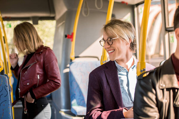 young man in eyeglasses in bus