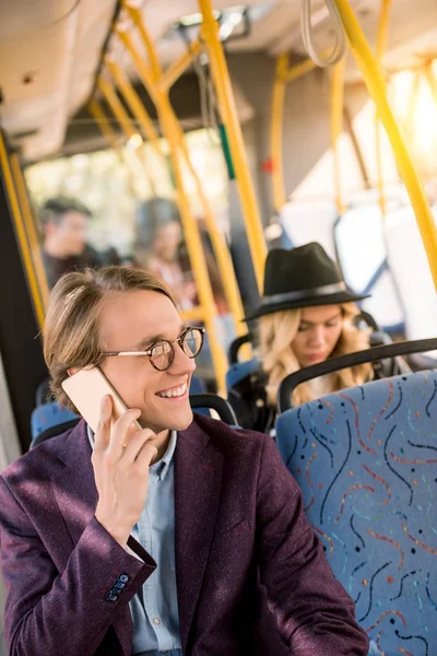 Man using smartphone in bus — Free Stock Photo