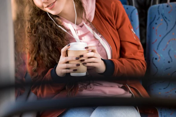 Girl drinking coffee in bus — Stock Photo, Image