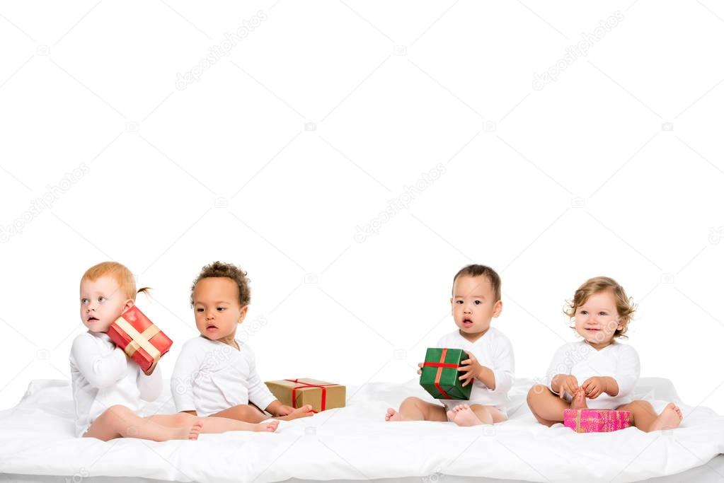 multiethnic toddlers with wrapped gifts