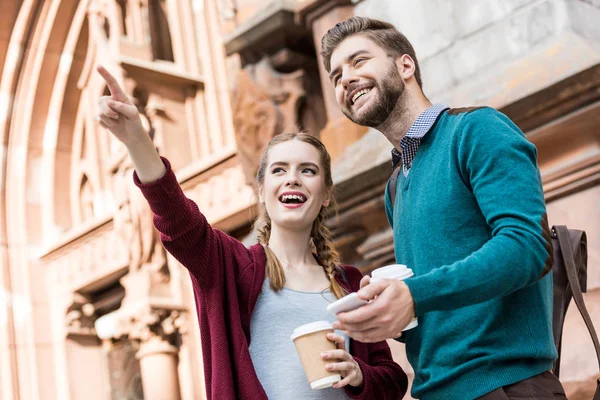 Couple with coffee to go on street — Stock Photo, Image