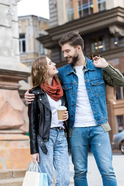 Pár s nákupní tašky na ulici — Stock fotografie