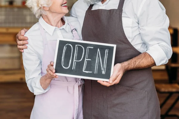 Coffee shop owners with open chalkboard — Stock Photo, Image