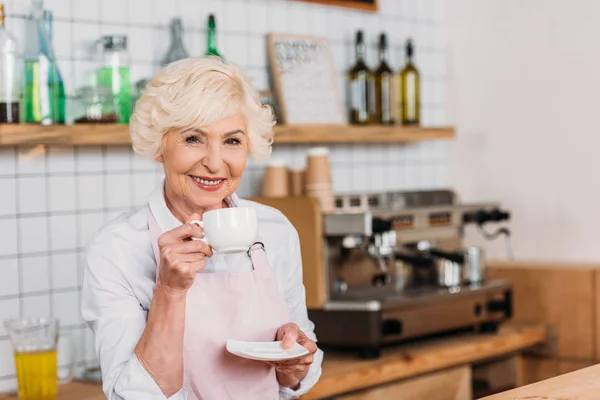 Cafe worker with cup of coffee — Stock Photo, Image