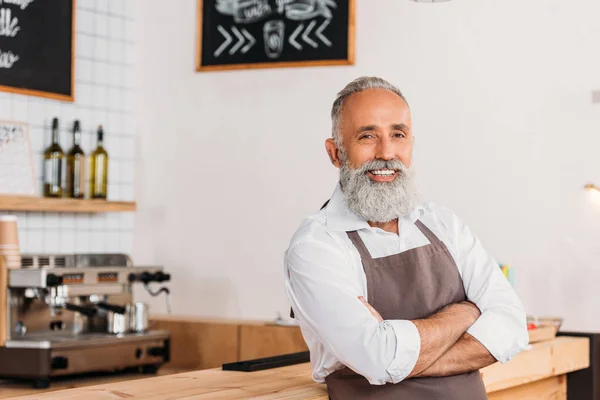 Trabajador senior de pie en el mostrador — Foto de Stock