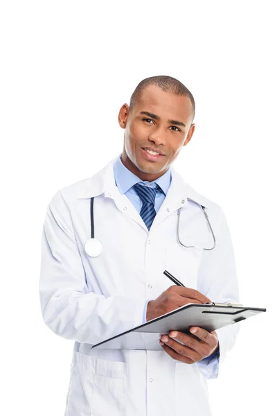 African american doctor writing diagnosis — Stock Photo, Image