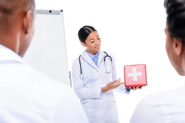 Doctor presenting first aid kit — Stock Photo, Image