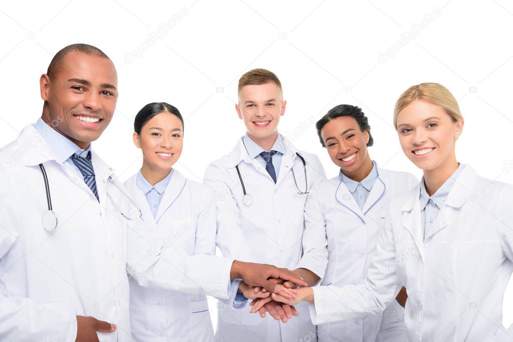 multiethnic doctors with hands together