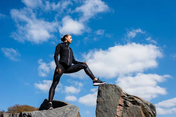 Sportieve vrouw op rotsen — Stockfoto