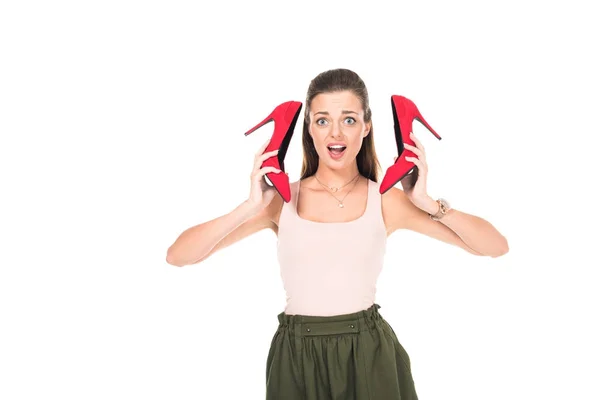 Woman holding pair of red shoes — Stock Photo, Image