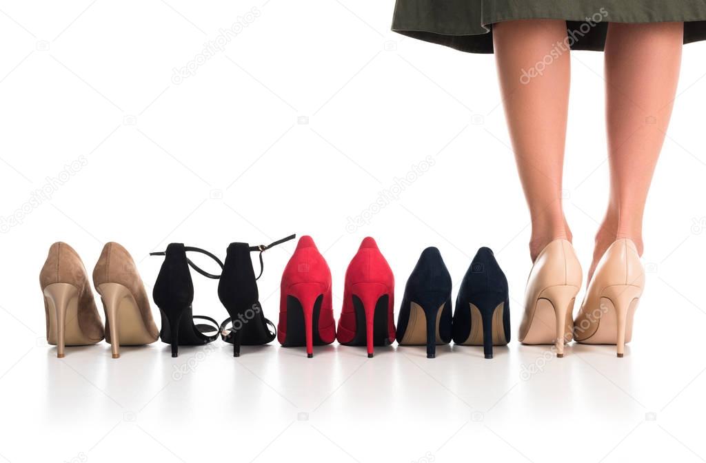 woman and arranged fashionable shoes