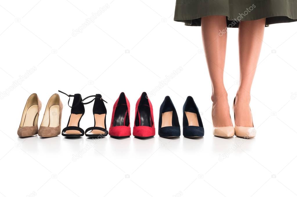 woman and arranged fashionable shoes
