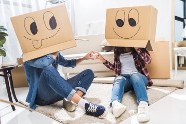 couple with boxes on heads clipart