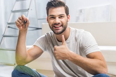 Happy man showing key clipart