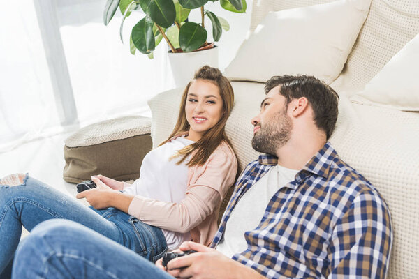 couple holding gamepads