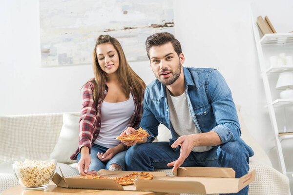 couple watching tv with snacks