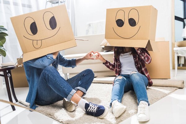 couple with boxes on heads