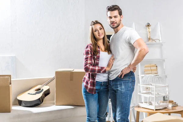 Attractive couple standing in living room — Stock Photo, Image