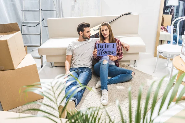 Couple with our first house sign — Stock Photo, Image