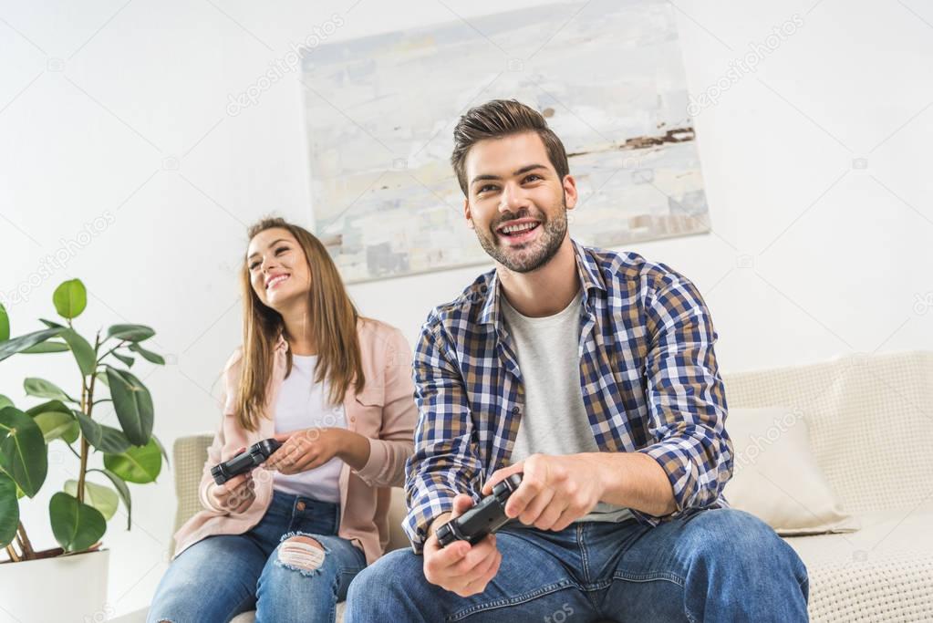 couple playing videogame with gamepads