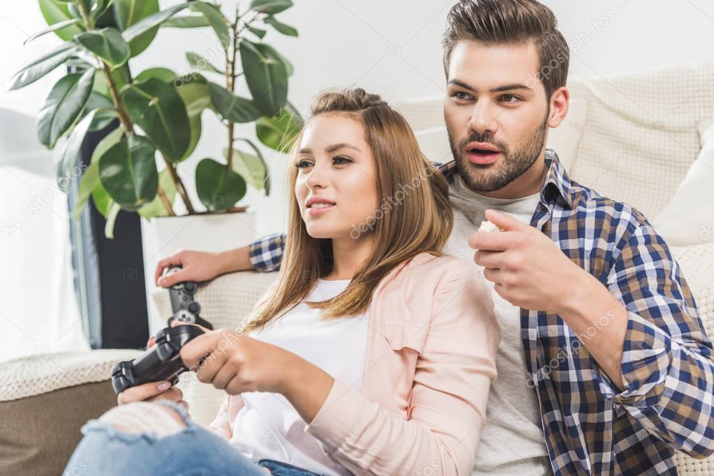 woman playing videogame with gamepad