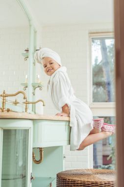 child in bathrobe and towel on head clipart