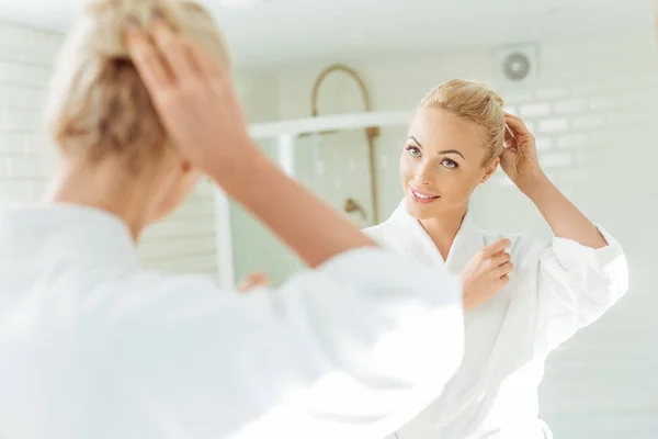 Beautiful woman looking at mirror — Stock Photo, Image