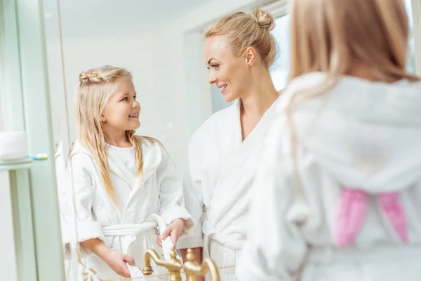 Mother and daughter in bathrobes — Stock Photo, Image