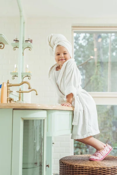 Kid in bathrobe and towel on head — Stock Photo, Image