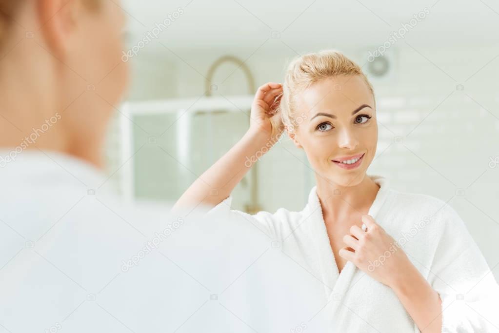 beautiful woman looking at mirror  