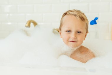 little boy in bathtub