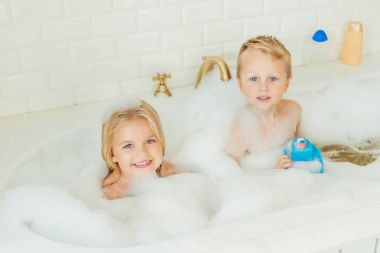 kids playing in bathtub with foam clipart