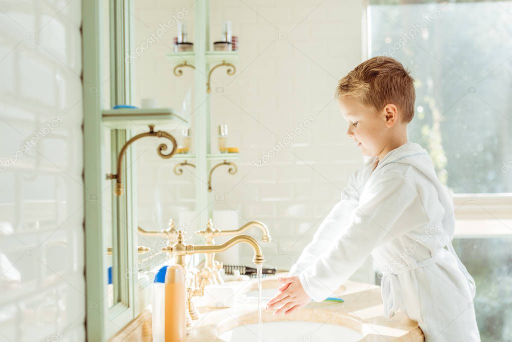 little boy washing hands