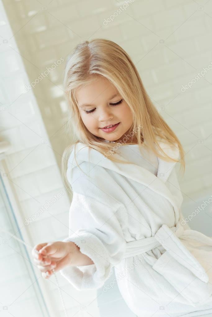 adorable child in bathrobe