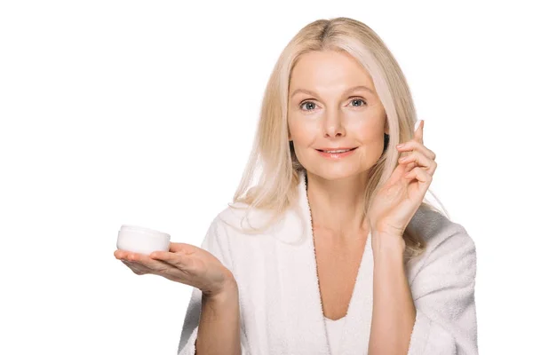 Mature woman applying cosmetic cream — Stock Photo, Image