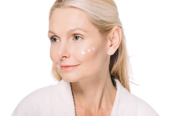 Mature woman with cosmetic cream on face — Stock Photo, Image