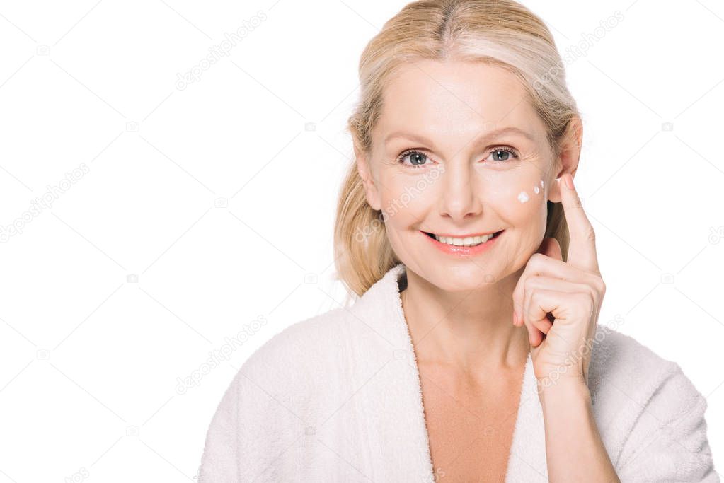 mature woman applying cosmetic cream