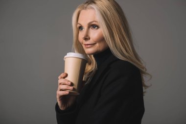 mature woman with coffee to go