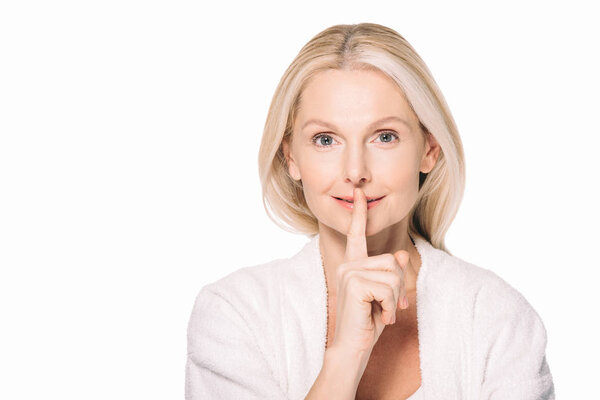 mature woman showing silence gesture