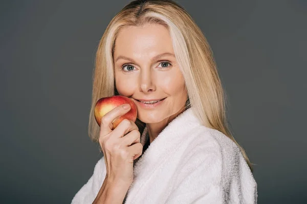 Middle aged woman with apple — Stock Photo, Image