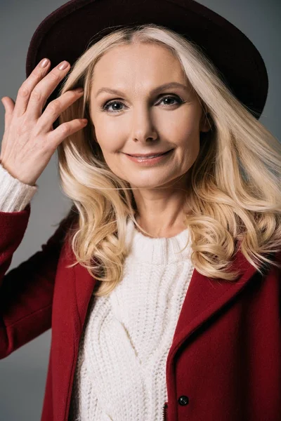 Mature woman in red coat and hat — Stock Photo, Image