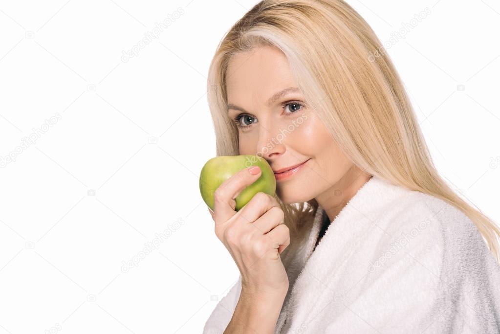 mature woman with green apple