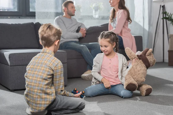 Kids playing with toys on floor — Stock Photo, Image