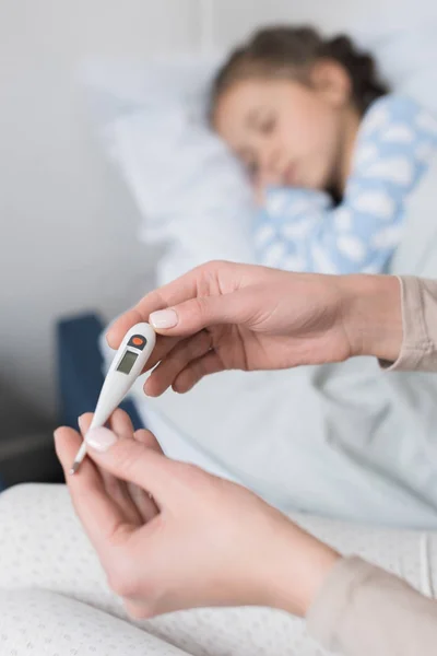 Woman looking at thermometer — Stock Photo, Image