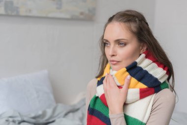 Sick woman in scarf over neck